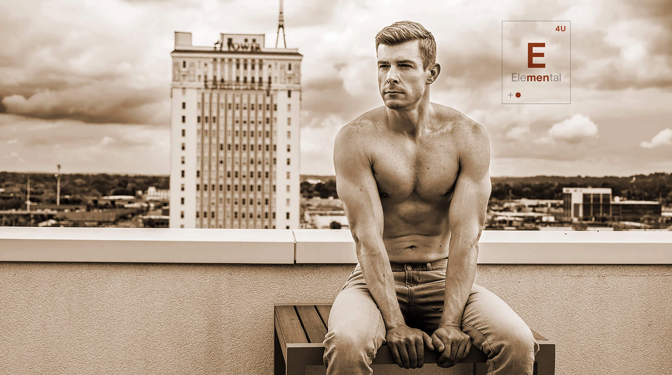 A shirtless man on the roof of a building framed by the Elemental logo
